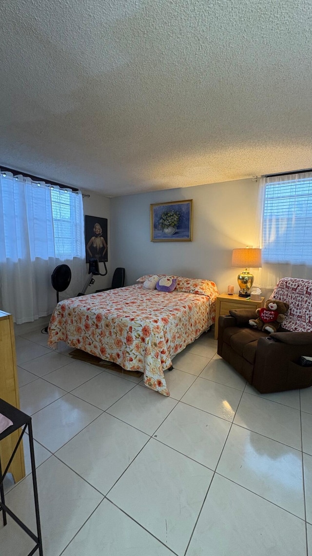 tiled bedroom with a textured ceiling