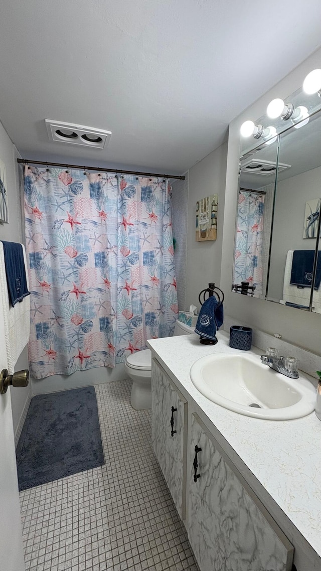 full bathroom with toilet, tile patterned floors, vanity, and shower / tub combo