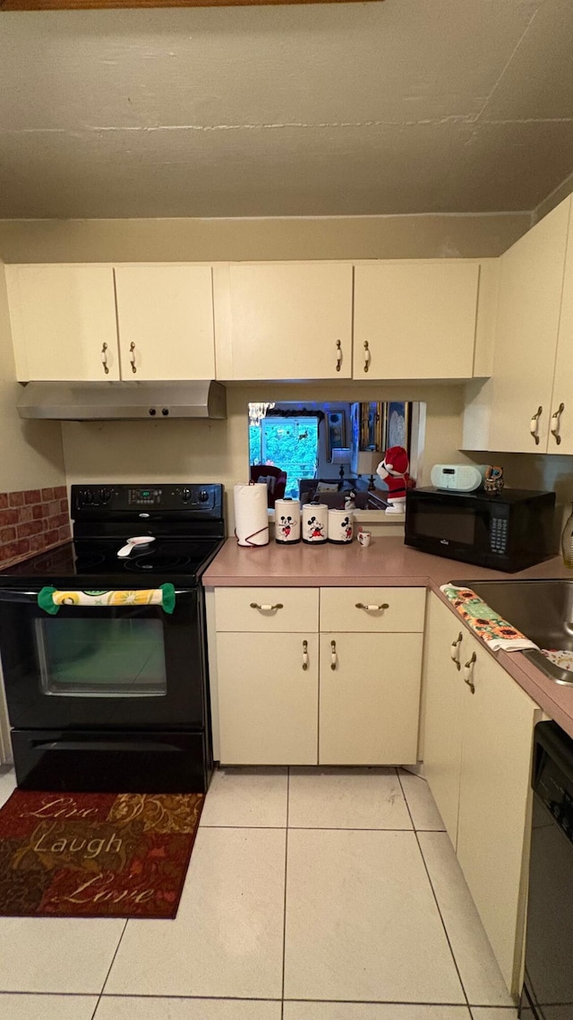 kitchen with black appliances, white cabinetry, and light tile patterned floors