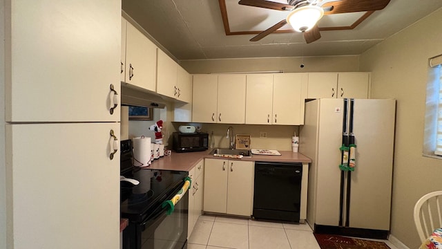 kitchen featuring light tile patterned floors, white cabinets, black appliances, and sink