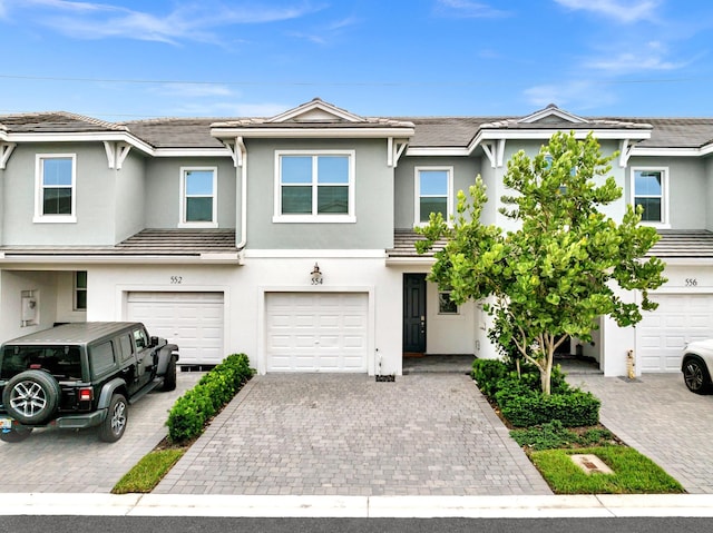 townhome / multi-family property featuring a garage