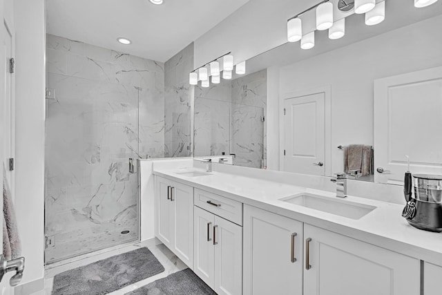 bathroom featuring a shower with shower door and vanity