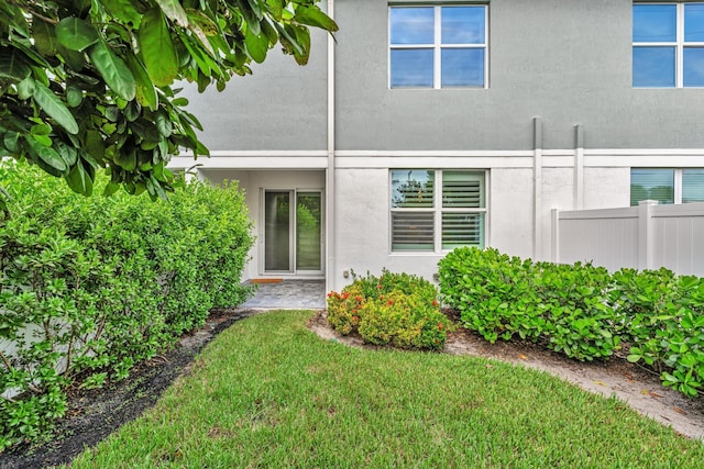 rear view of property featuring a yard