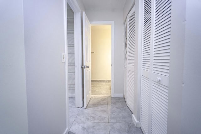 hallway with light tile patterned floors