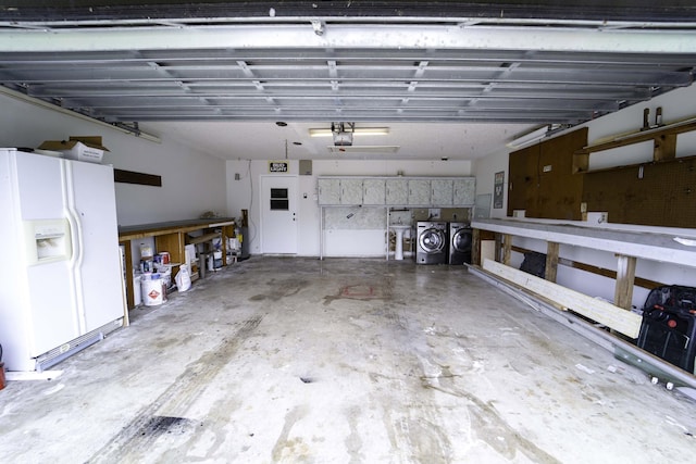 garage with a garage door opener, washer and dryer, and white refrigerator with ice dispenser