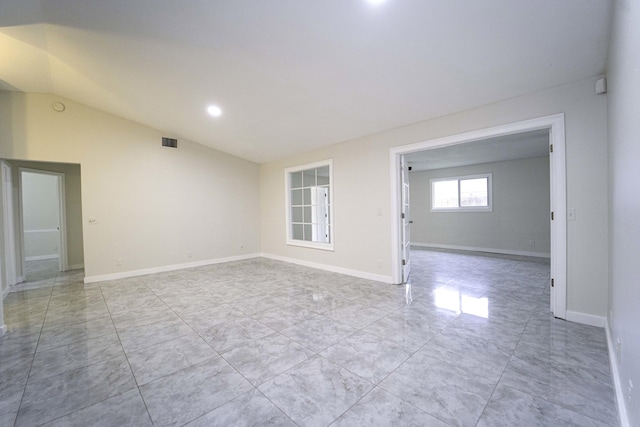 unfurnished room with lofted ceiling