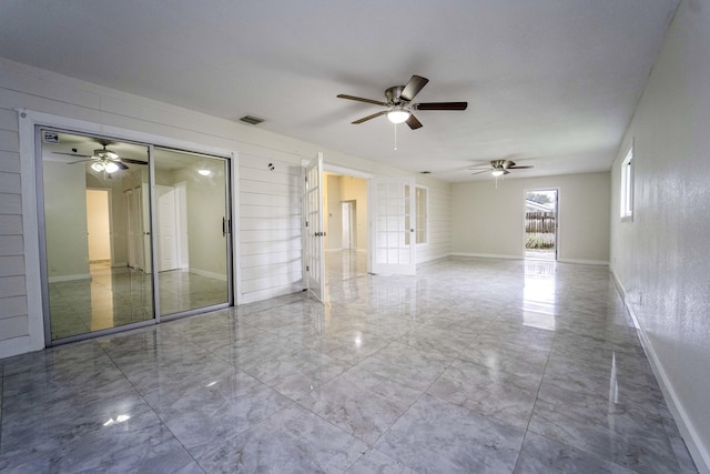 unfurnished room with wood walls