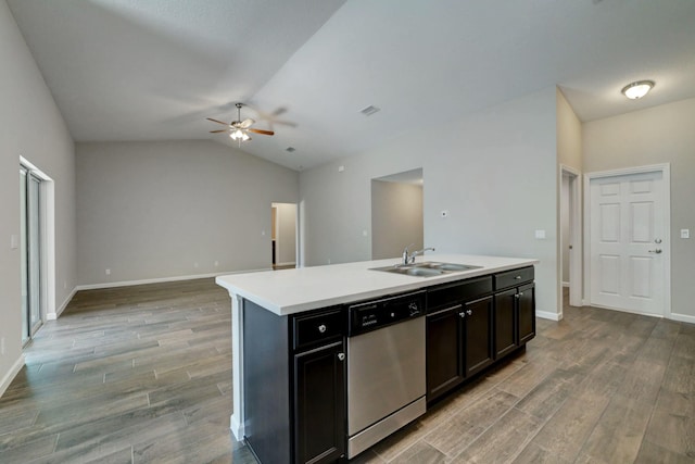 kitchen featuring sink, vaulted ceiling, stainless steel dishwasher, an island with sink, and ceiling fan