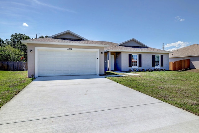 single story home featuring a garage and a front lawn