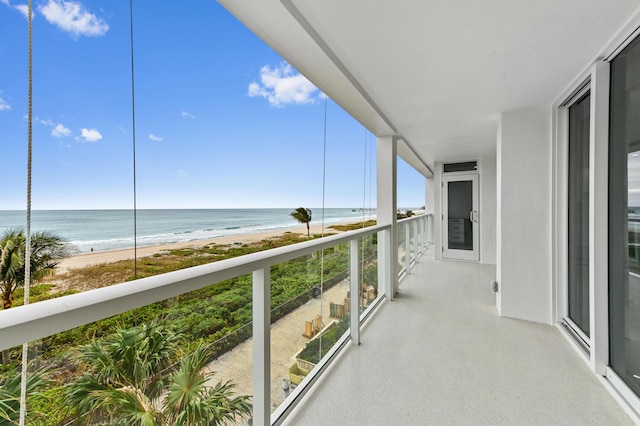 balcony featuring a water view and a view of the beach