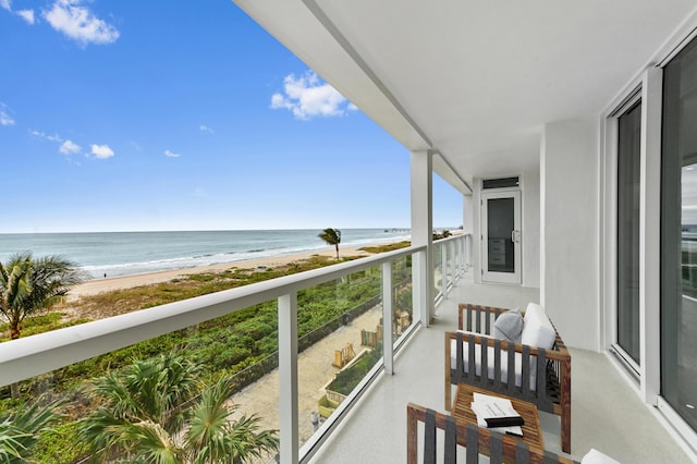 balcony featuring a water view and a view of the beach