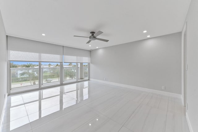 tiled empty room featuring ceiling fan