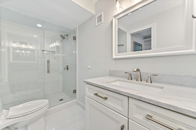 bathroom with walk in shower, tile patterned floors, vanity, and toilet