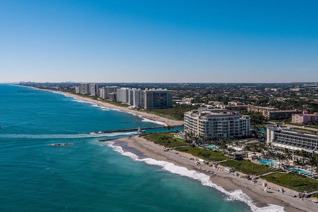 drone / aerial view featuring a water view and a beach view