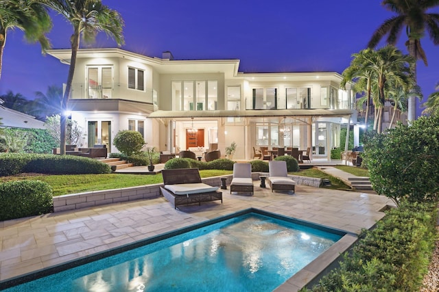 back of property featuring an outdoor hangout area, a patio area, and french doors