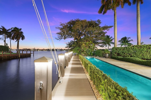 pool at dusk with a water view