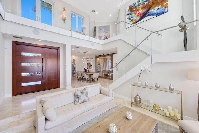 foyer with a towering ceiling and a notable chandelier