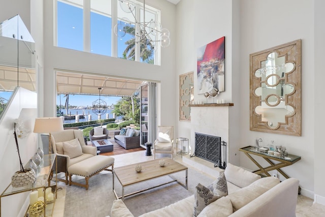 living room with an inviting chandelier, a towering ceiling, and a wealth of natural light