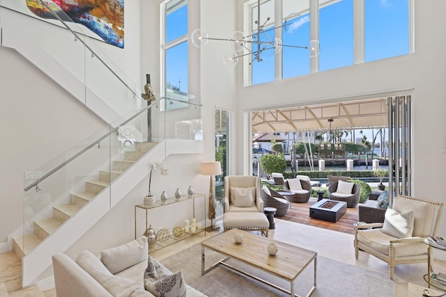 living room with a notable chandelier and a towering ceiling