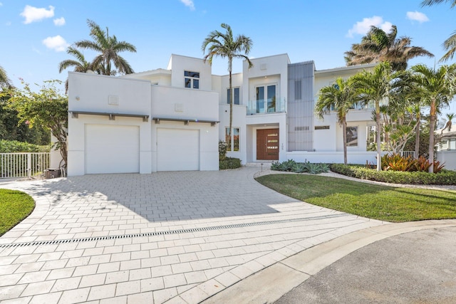 view of front of home featuring a garage and a balcony