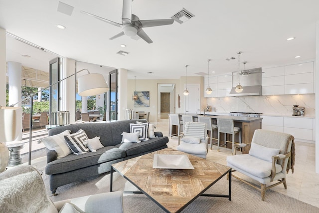 living room with ceiling fan, floor to ceiling windows, and light tile patterned floors