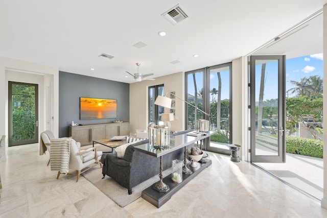 living room featuring a wealth of natural light and a wall of windows