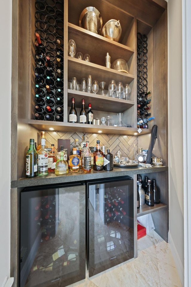 bar featuring wine cooler and decorative backsplash