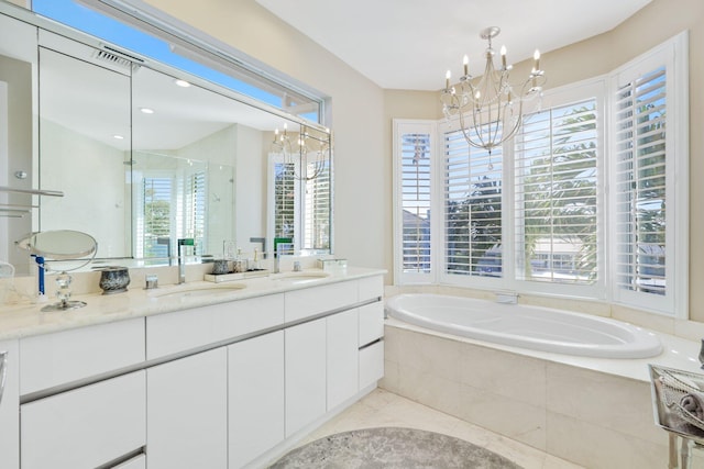 bathroom featuring vanity, a notable chandelier, and plus walk in shower