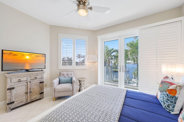 bedroom with light tile patterned flooring, ceiling fan, french doors, and access to outside