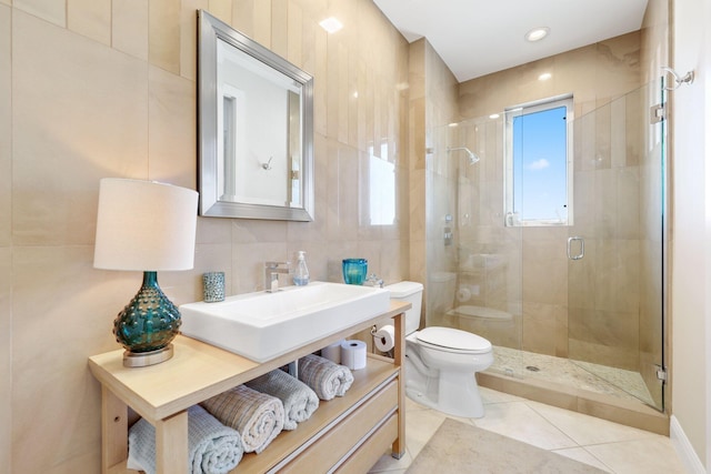 bathroom with tile walls, backsplash, a shower with shower door, tile patterned floors, and toilet