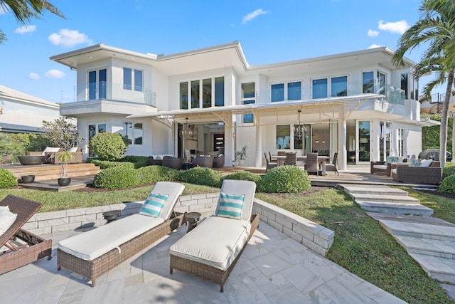 back of property with a patio and outdoor lounge area