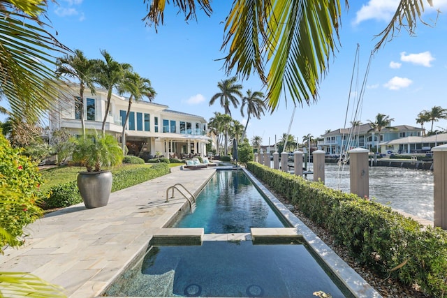 view of swimming pool featuring a water view