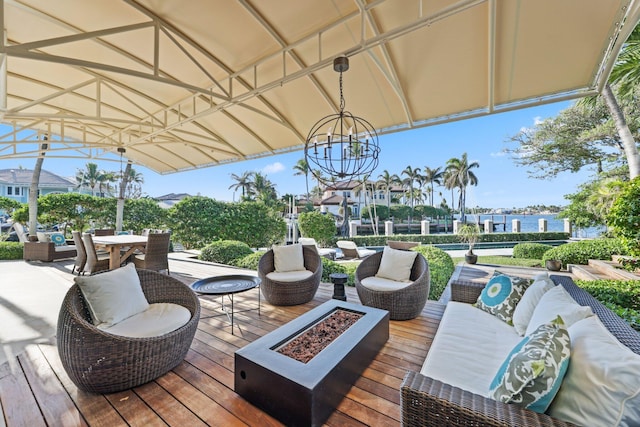 wooden terrace featuring an outdoor living space with a fire pit