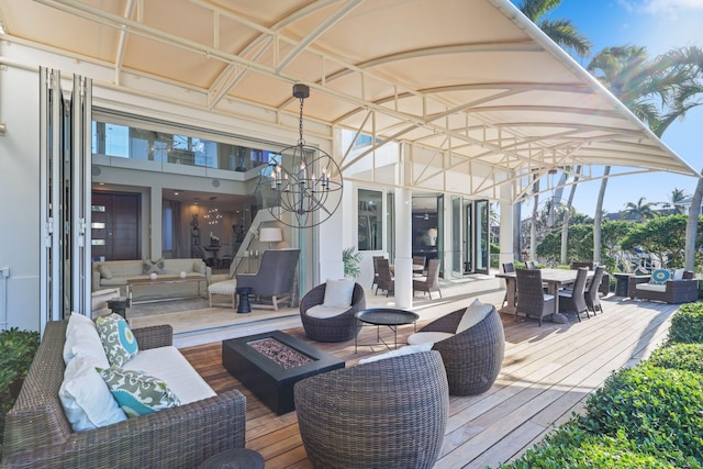 wooden terrace with an outdoor living space with a fire pit