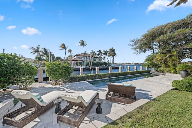 view of swimming pool with a water view and a patio area