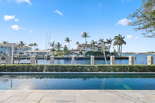 view of pool featuring a water view