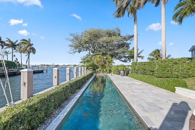 view of pool featuring a water view and a boat dock