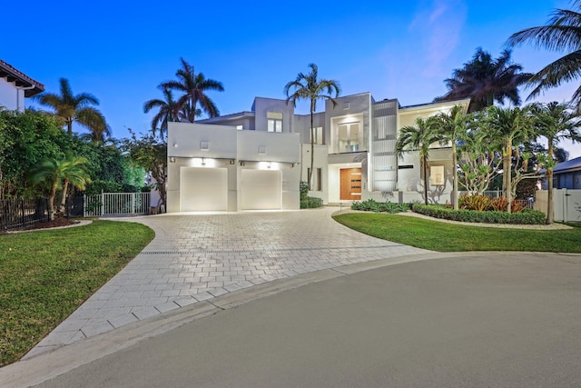 view of front of house with a yard and a balcony