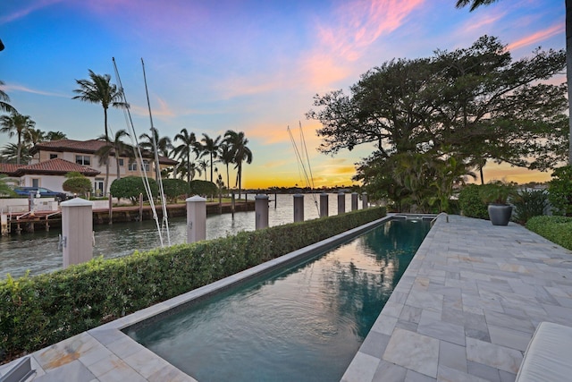 pool at dusk with a water view