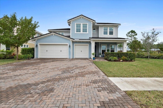 view of front facade with a porch, a garage, and a front yard