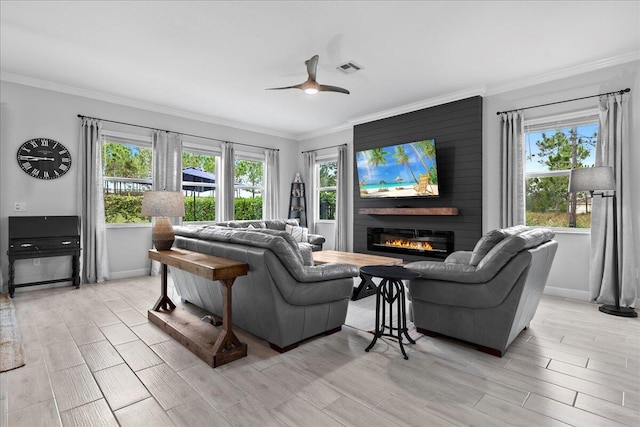 living room with crown molding, a large fireplace, and ceiling fan