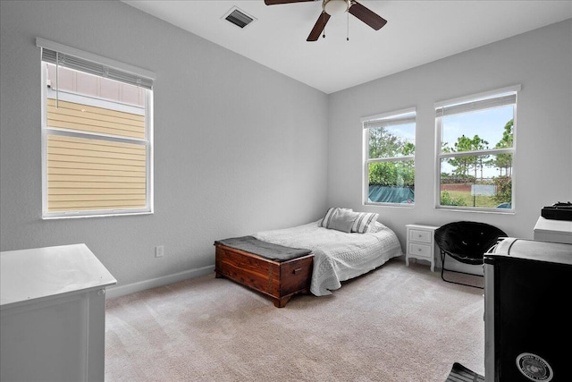 bedroom featuring light carpet and ceiling fan