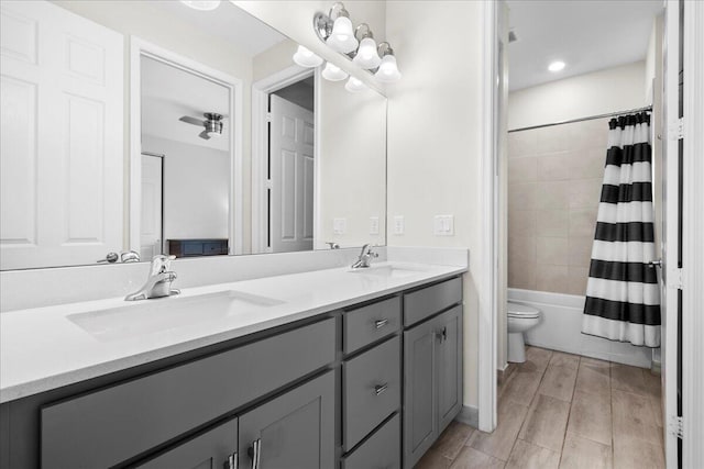 full bathroom featuring vanity, shower / bathtub combination with curtain, and toilet