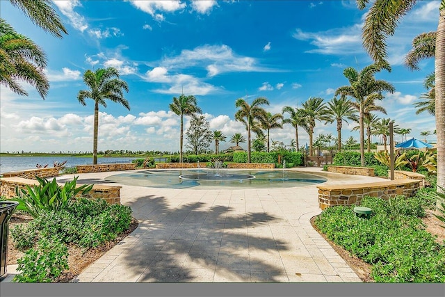 view of swimming pool with a water view