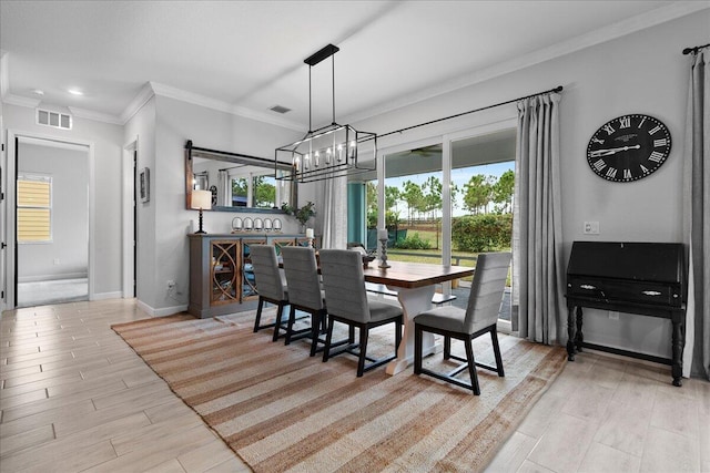 dining room with an inviting chandelier and ornamental molding