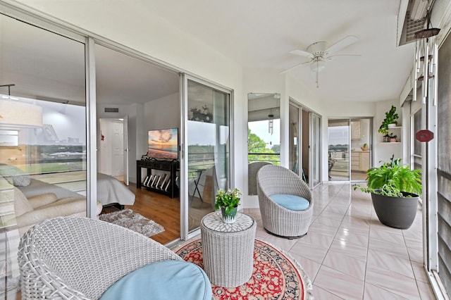 sunroom / solarium featuring a ceiling fan and visible vents