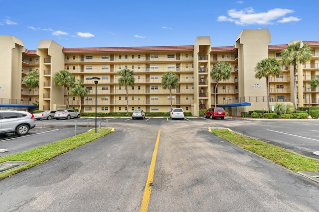 view of building exterior featuring uncovered parking