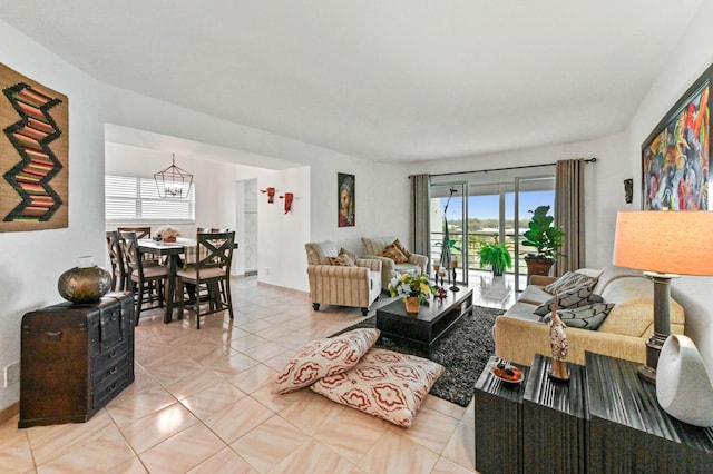 living room with light tile patterned floors and a notable chandelier