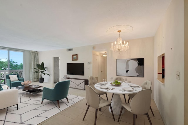 tiled dining room featuring a chandelier