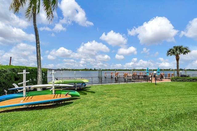 exterior space with a water view and a lawn